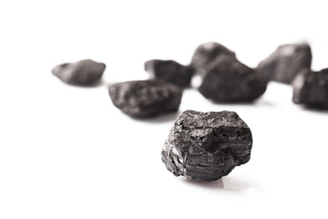 Some loose lumps of coal on white background