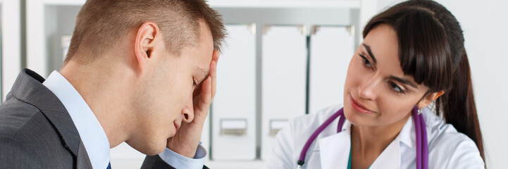 Fototapeta premium Concerned beautiful female medicine doctor listening carefully p