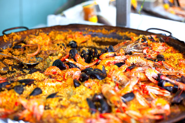 Traditional paella with seafood in a market