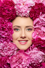 Beautiful girl with pink peony flowers
