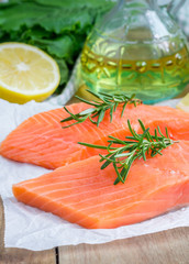 Fresh raw salmon fillet with rosemary and lemon