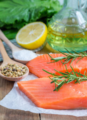 Fresh raw salmon fillet with rosemary and lemon