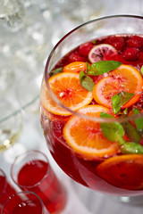 Red Lemonade cocktail with fresh orange on white background