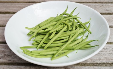 Plate of French green beans freshly picked from the vegetable garden