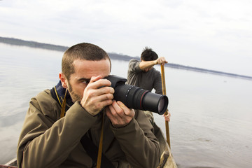 Obraz premium Men in boat on the river, shooting, adventure, real