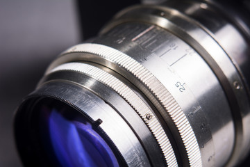Fototapeta na wymiar Close-up lens Photo Film camera metallic color with a purple ref