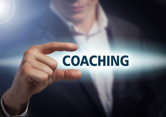 Businessman presses button coaching on virtual screens. Business