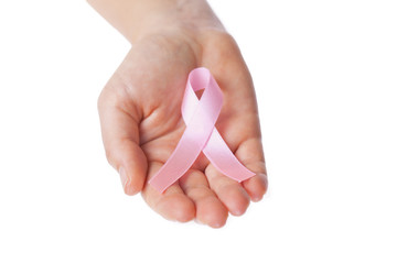  woman`s hands holding pink breast cancer awareness ribbon

