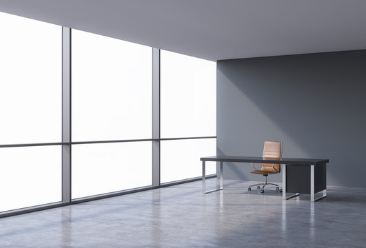 A workplace in a modern panoramic office, copy space on windows. A brown leather chair and a black table. A concept of financial consulting services. 3D rendering.
