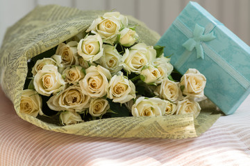 Beautiful wedding bouquet of beige roses with gift