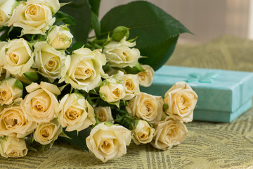 Beautiful wedding bouquet of beige roses with gift