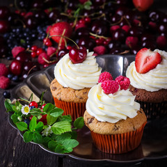 Cupcakes on metal tray decorated with berries