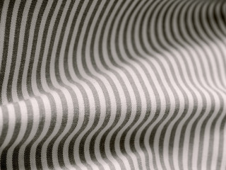 Black and white cloth material fragment as a background texture.