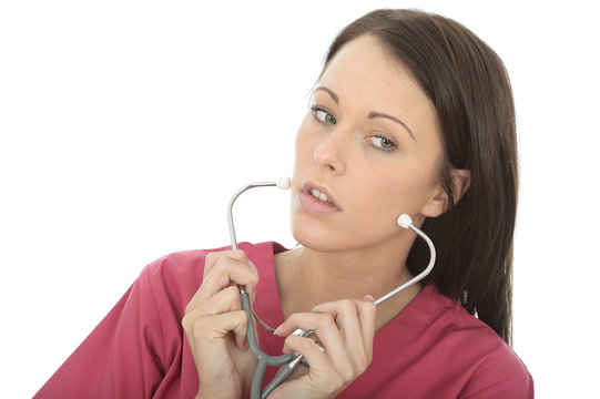 Portrait Of A Beautiful Young Female Doctor Putting On A Stethoscope