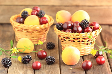 basket of summer berries - apricots, blackberries, and cherries.