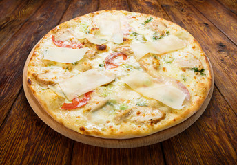 Delicious pizza with chicken, parmesan and fresh arugula