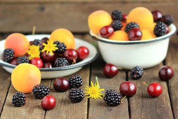 Plate of summer berries - apricots,  blackberries, and cherries.