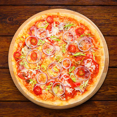 Delicious pizza with onions, bacon and cherry tomato