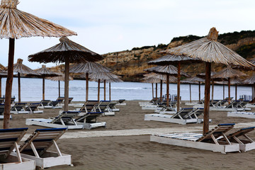 Beach umbrellas at the hotel lounge chairs