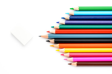 Colored pencils on white paper and erasers