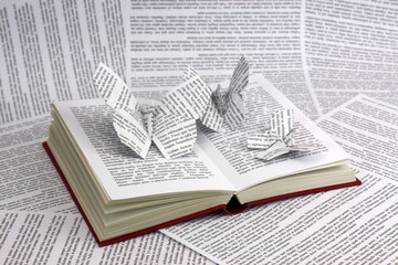 Origami butterflies coming out of a book