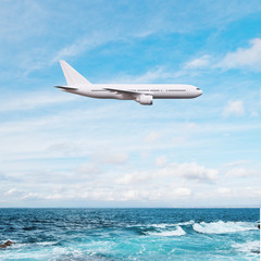 Fototapeta na wymiar airplane flying over ocean