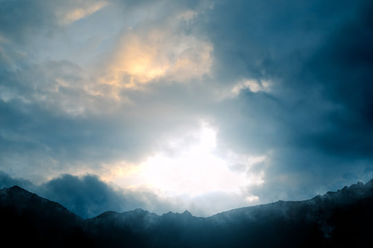 Nature - Mountain scenery with a dramatic sky against the light - computer generated image