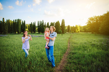 Fototapeta premium Family playing with a kite outdoor