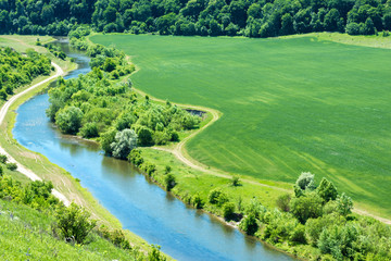 Landscape of river and green wheat field