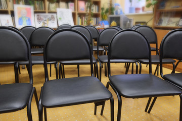 Rows of black chairs in the hall