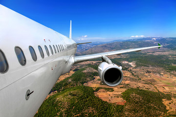 Passenger airplane flying over the ground