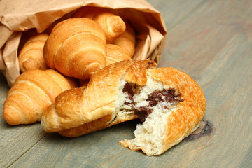 Croissants on wooden background