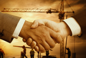Construction concept with business handshake