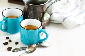 Cups of coffee and coffee pot.