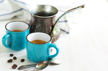 Cups of coffee and coffee pot.