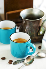 Cups of coffee and coffee pot.