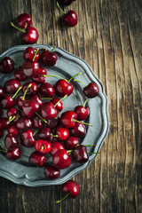 Sweet cherries on vintage plate. Top view