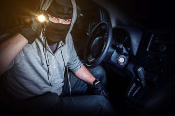 Car Thief with Flashllght