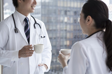 Doctors are drinking coffee at the window