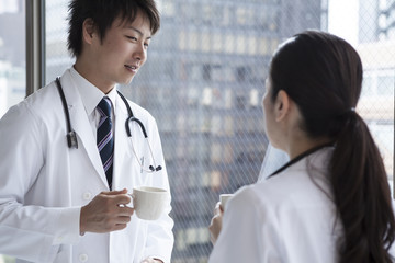 Doctors are drinking coffee at the window