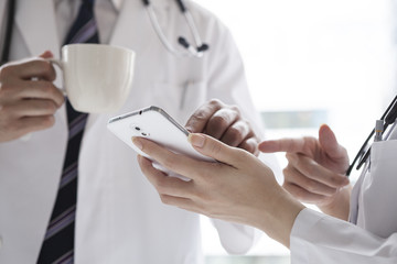 Two doctors are resting at the window
