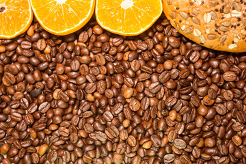 Whole wheat bread and  pieces orange on roasted coffee