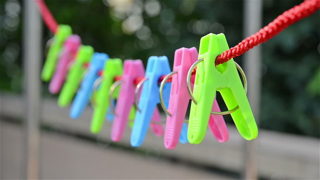 clothespins hanging on rope in wind