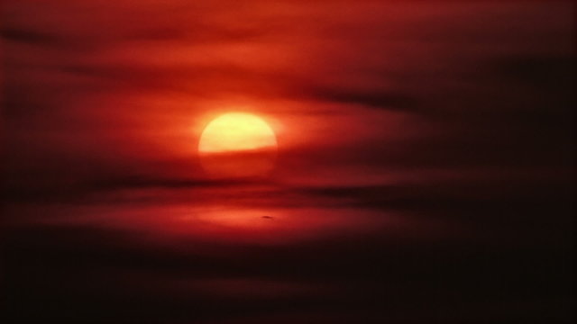 Tropical sun quickly rises up behind the clouds. FullHD 1080p.
