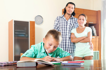 Fototapeta na wymiar parents watching their son doing homework
