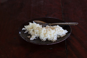 cooked rice in dish on the wooden table