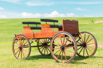 Fototapeta na wymiar historic carriage on beautiful field and Blue skies 