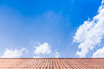 Tile roof and blue sky on a sunny day with slightly cloudy