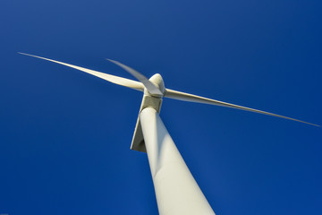Turbin wind power in southern Italy. Blue sky, white blades, wind whistling between the blades...