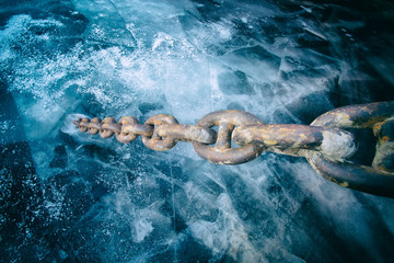 Tightly stretched chain frozen in the ice - Powered by Adobe